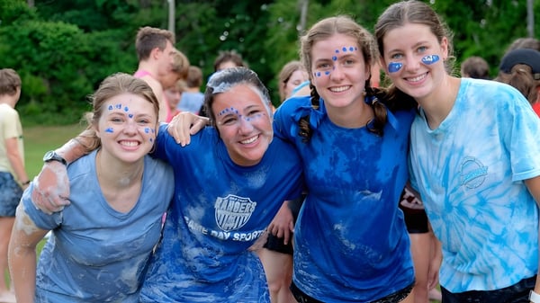 Un grupo de estudiantes de la Bayshore Christian School está reunido en el área exterior verde.