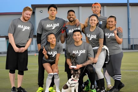 Un grupo de estudiantes está en el campo de deportes de la Burnaby North School y lleva camisetas de equipo.