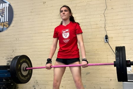 Una estudiante de Carleton Place High School entrena con un peso en el gimnasio.