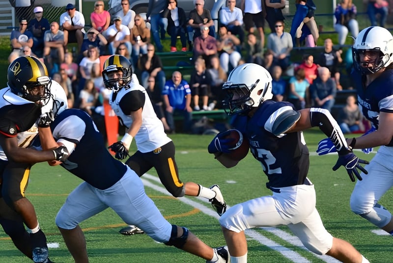 Un grupo de futbolistas del College Bourget juega un partido en un campo de césped con espectadores al fondo.