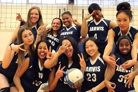 Un grupo de jóvenes estudiantes del Jarvis Collegiate Institute en uniformes deportivos posan juntas en un edificio deportivo.