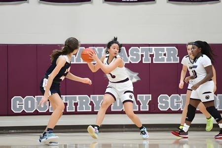 Las estudiantes juegan baloncesto en el campo de deportes de Lancaster Country Day School.