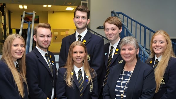 Un grupo de estudiantes está en el pasillo del Perth & District Collegiate Institute.