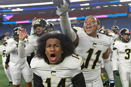 Estudiantes de la Springfield Central State High School celebran en el campo de fútbol frente al estadio.