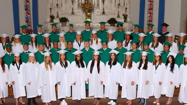 Estudiantes de la St. Joseph Catholic High School celebran una ceremonia en un espacio religioso con símbolos religiosos.