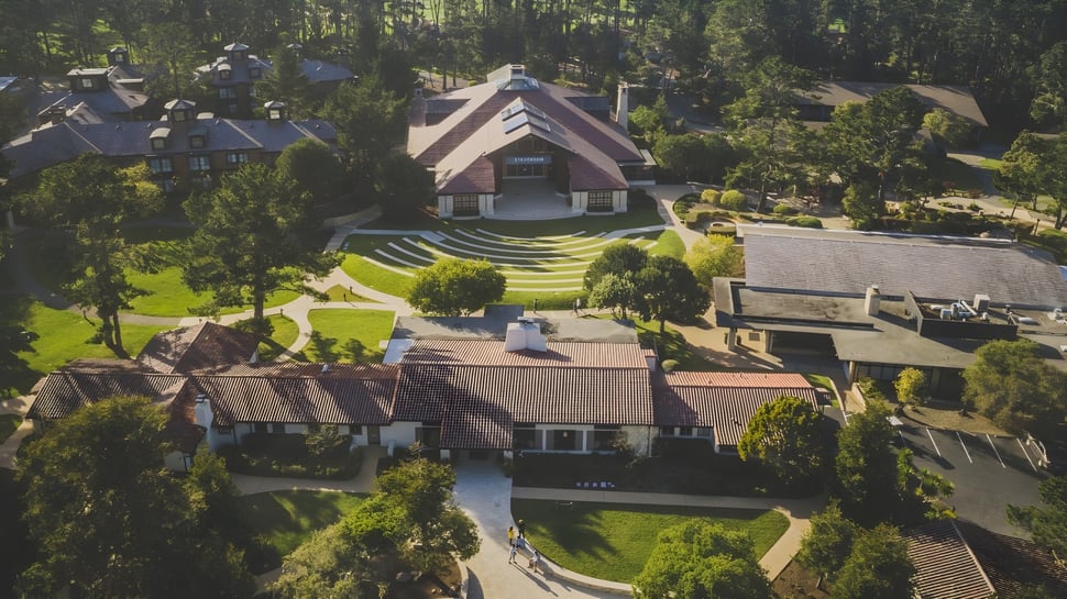 El edificio principal de la Stevenson School está incrustado en un paisaje boscoso con césped bien cuidado en primer plano.