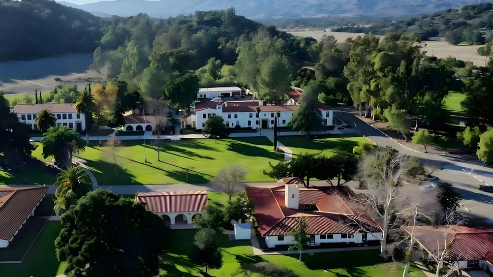 El paisaje verde alrededor de la propiedad de la Villanova Preparatory School con un lago y bosques al fondo.