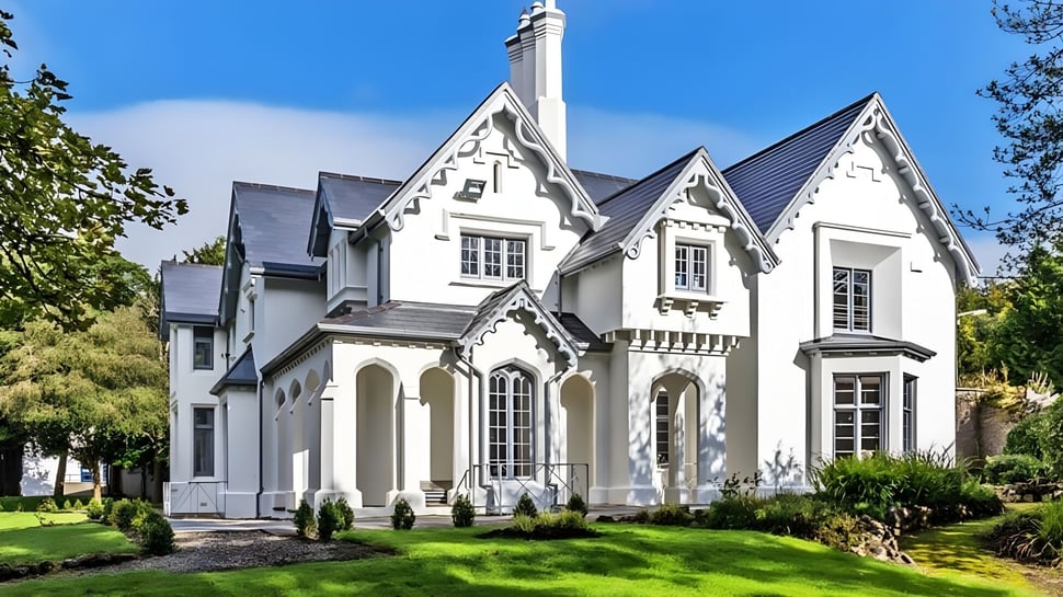 La casa victoriana en el campus de la Villiers School está rodeada de césped cuidado y vegetación verde.