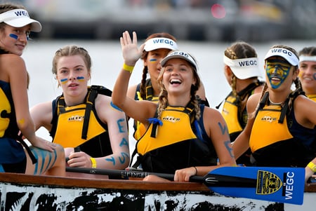 Las alumnas del Wellington East Girls’ College animan con uniformes amarillos durante un evento.