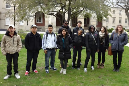 Un grupo de estudiantes está frente a un edificio histórico en el campus de la Western Technical-Commercial School.
